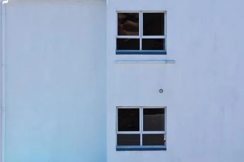 Plain Building Wall With Gutter And Windows Stock Photos