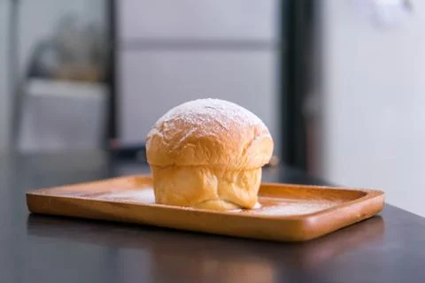 Plain butter bread with icing sugar powder on wooden plate Stock Photos