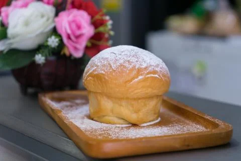 Plain butter bread with icing sugar powder on wooden plate Stock Photos