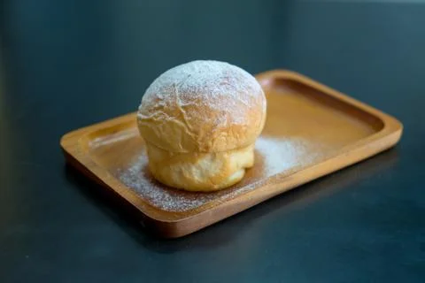 Plain butter bread with icing sugar powder on wooden plate Stock Photos