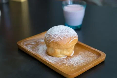 Plain butter bread with icing sugar powder on wooden plate Stock Photos