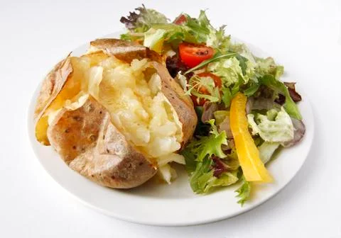 Plain butter jacket potato with side salad Stock Photos