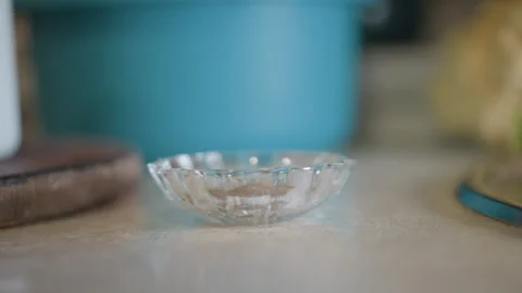 Plain dish awaiting ingredients. Calm domestic kitchen environment showcasing Stock Footage 346401153