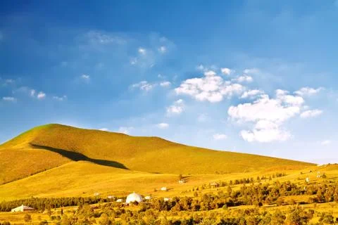 Plain with grass under blue sky Stock Photos