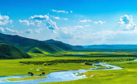 Plain, grasslands, river and mountain Stock Photos