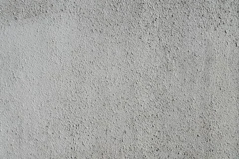 Plain gray textured plastered wall. Rough textured background with copy space Stock Photos