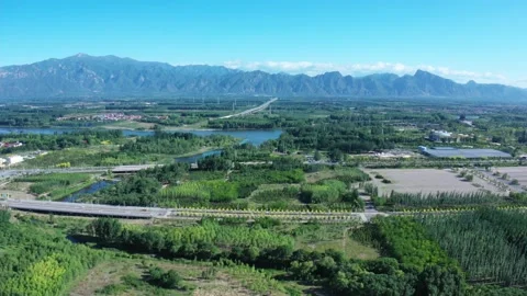 Plain green space and distant mountains sunny day Video stock 166790192