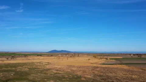 Plain with hills in the distance.drone shot moving up Stock Footage 126536928