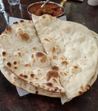 Plain Naan Bread served at a restaurant Stock Photos