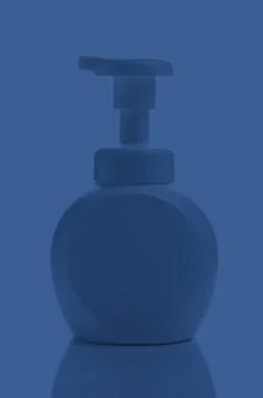 Plain plastic bottle with pump dispenser at night time Stock Photos