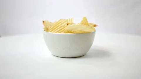 Plain Potato Chips spinning over white Stock Footage 84635807