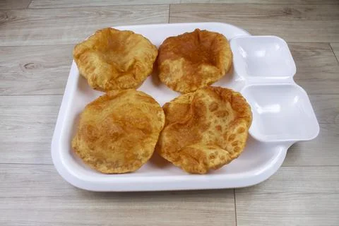 Plain Puri served in a plate. It's an Indian deep-fried bread made from who.. Stock Photos
