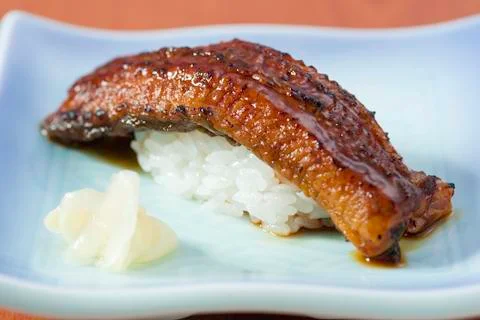 Plain rice with fried eel on white platter Stock Photos
