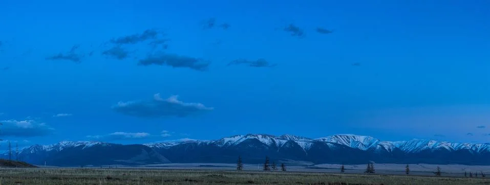 Plain at root of mountains Stock Photos