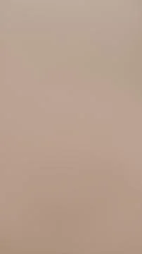 Plain smooth beige surface with soft gradient lighting Stock Photos