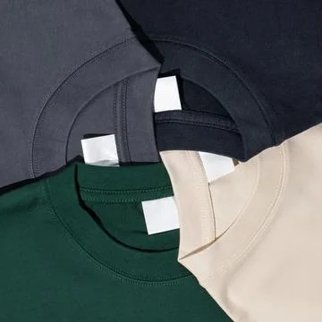 Plain t-shirts assorted colors with blank label. Stock Photos