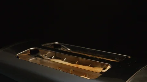Plain white bread pops out of a toaster when ready. Toast and toaster isolated o Stock-Footage 118064037
