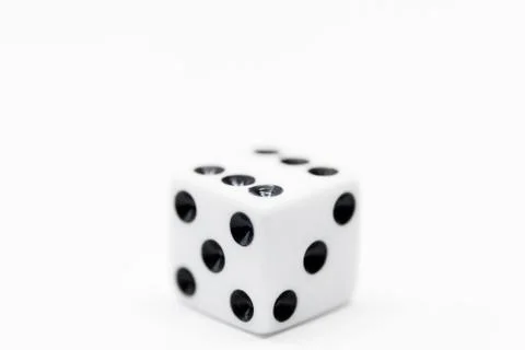 A plain white dice on white background in close up Stock Photos