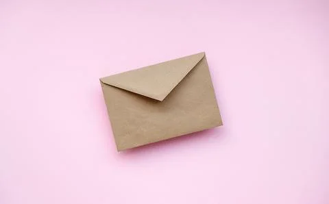 A plain white envelope placed on a ligh pink background. Perfect for mailin.. Stock Photos