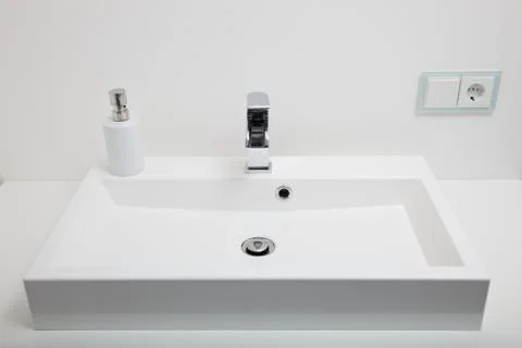 Plain white hand basin in a bathroom Stock Photos