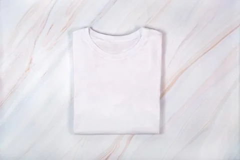 Plain white tshirt on marble background. Blank white t-shirt on marble texture Stock Photos