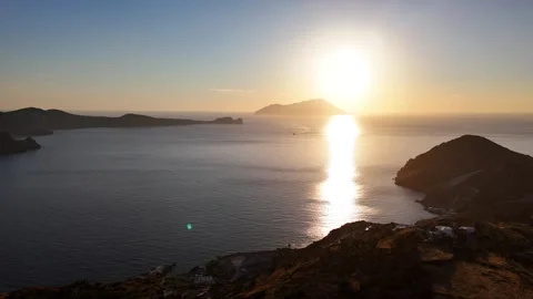 Plaka sunset over Milos Bay with Kastro hillside and distant volcanic islands Stock Footage 346296758