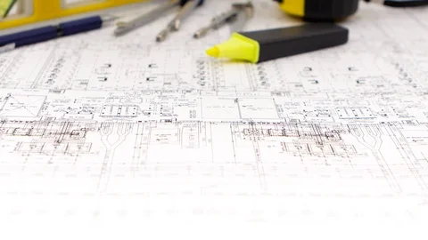 Plan of the building is with a dividers and a tape measure. Closeup Stock Footage 73671402