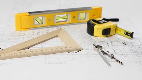 Plan of the building is with a dividers and a tape measure. Closeup Stock Footage 73672684