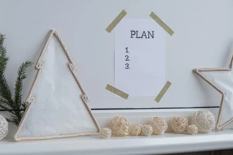 PLAN checklist text on paper note stick on while wall with cozy minimalistic Stock Photos