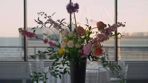 Plan a chic event with stunning flowers at a contemporary venue at sunset Stock Footage 290849124