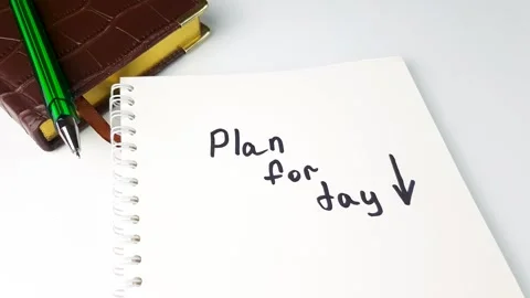 Plan for day writing in marker on notepad. Plan for day,scheduling day goals Stock Footage 281592299