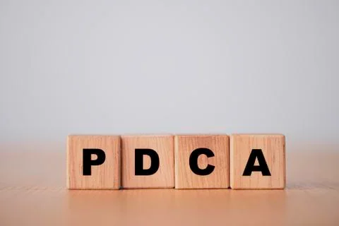 Plan do check action concept , PDCA printed screen on wooden cube block. Stock Photos