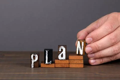 PLAN. Future, new year and business concept. Wooden alphabet letters on steps Stock Photos