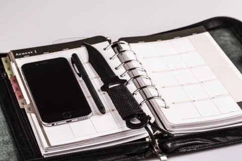 Plan for murderer - calendar, planner, cellphone, pen and knife as weapon Stock Photos