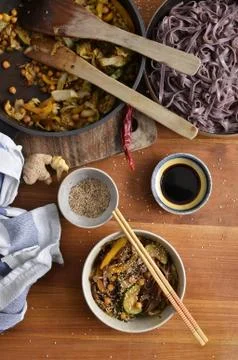 Plan portrait view of stir fried vegetables with black rice noodles, served i Stock Photos