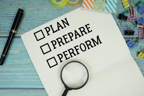 Plan, Prepare, Perform text on a paper surrounded by office supplies and ma.. Stock Photos