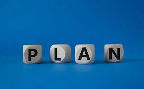 Plan symbol. Concept word Plan on wooden cubes. Beautiful blue background. .. Stock Photos
