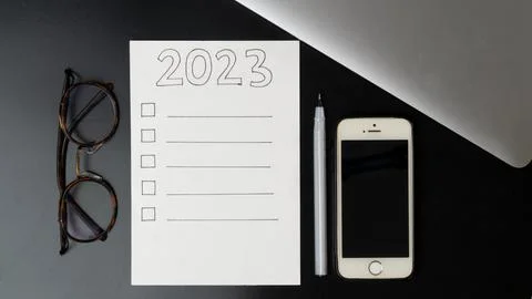 Plan things for the new year 2023, a blank checklist, glasses, phone and laptop Stock Photos