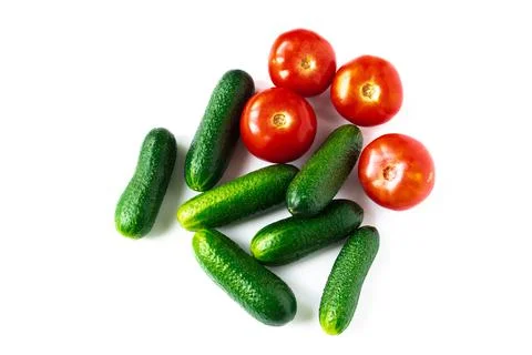 Plan view of green fresh cucumbers and red tomatoes isolated on white backgro Stock-Fotos