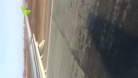The plane accelerates and takes off from the runway. view of the aircraft wing Stock Footage 153151694