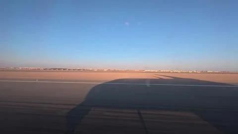 The plane accelerates on the Hurghada runway, with its shadow racing beneath Stock Footage 305523815
