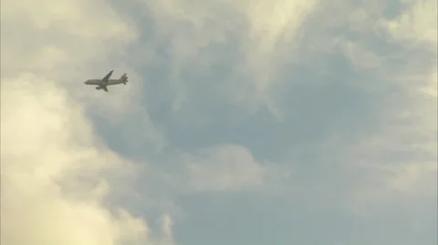 Plane in air with zoom out to beach at sunset Stock Footage 25180294