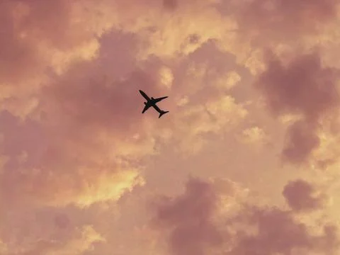 The plane and the clouds Stock Photos