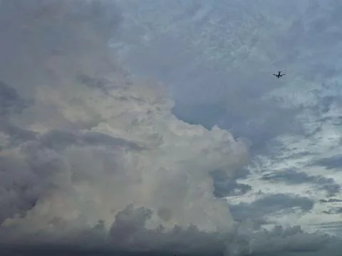 The plane and the clouds Stock Photos