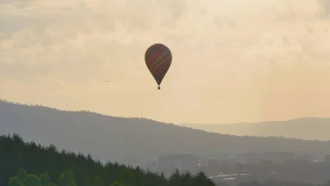 Plane and Hot Air Balloon over the hills Video stock 338174180