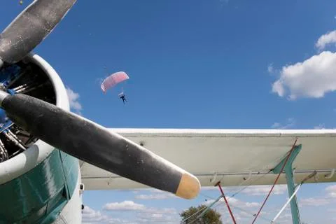 Plane  and landing parachutists 写真素材