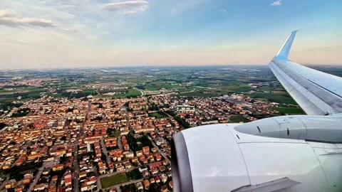 Plane approaches the ground preparing to land near the city of Verona Stock Footage 339542481