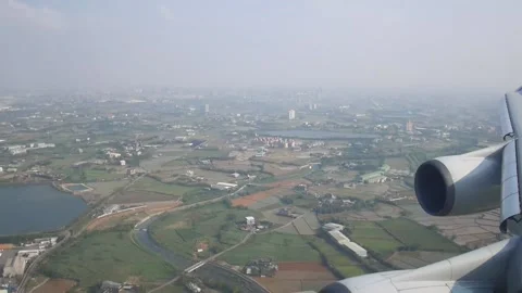 Plane arriving land view from plane's window Stock Footage 164516229