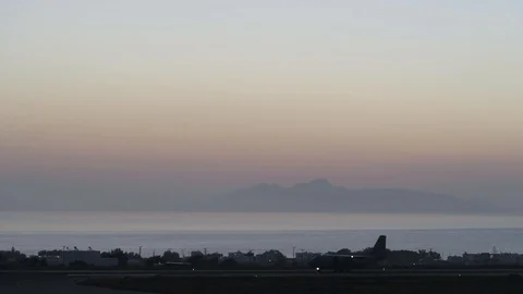 Plane arriving on the runway at sunrise Stock Footage 101728144