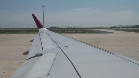 The plane is backing up the runway view from the porthole. Stock Footage 119713111